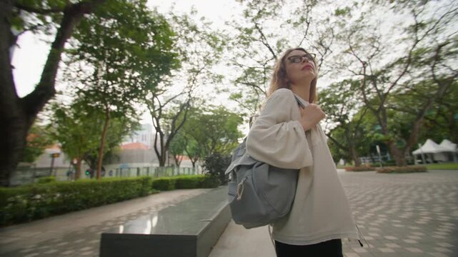 Caucasian woman enjoying a walk through Singapore downtown with spectacular skyscrapers modern cityscape and unforgettable tourism experience in Asia