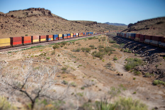 Miniature effect freight train in desert landscape