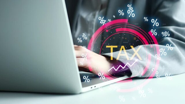 A person sits at a desk with a laptop open while working on tax documents. Various tax symbols and numbers are shown around the screen. This scene suggests an office setting.
