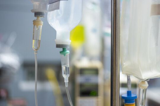 Close up intravenous drip system delivering fluid hospital highlighting patient care emergency treatment healthcare technology clinical medicine