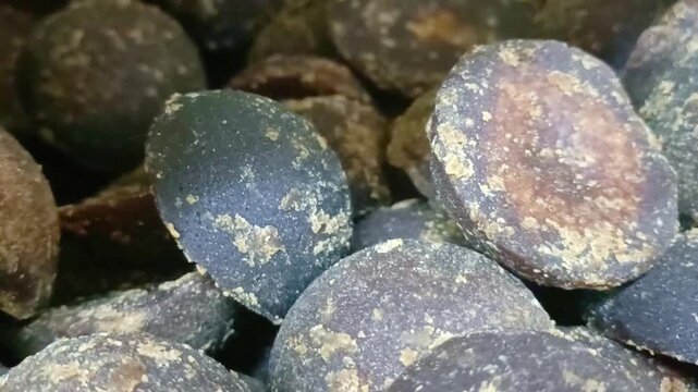 Macro shot of organic palm sugar jaggery blocks used as a natural sweetener in Asian cooking.
