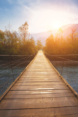 Fototapeta premium Hanging rope wooden bridge over mountain river