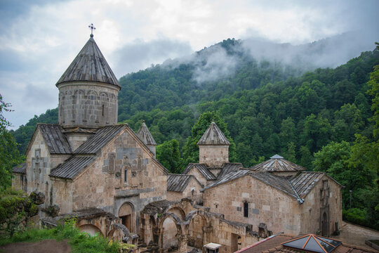 Ancient Haghartsin monastery in misty mountains of Armenia with copy space