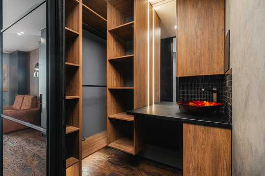 Wooden open shelving unit integrated with a bathroom vanity
