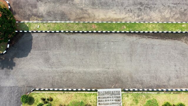 Top down aerial view of an empty asphalt road with copy space and geometric urban design.