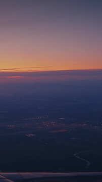 Dramatic Sunset with Landscape Transition Below Airplane