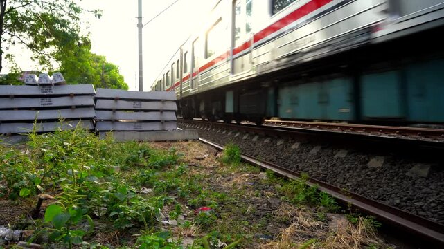 Commuter train passing on railway tracks
Motion blur shot of a modern commuter train passing rapidly over steel railway tracks at an urban railroad crossing and representing public transportation