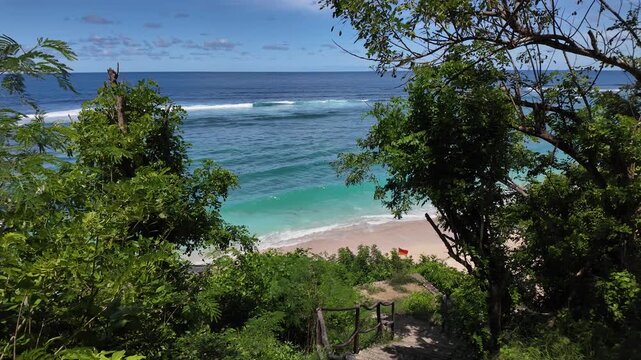 Turquoise cove framed by trees at Gunung Payung Beach, Bali