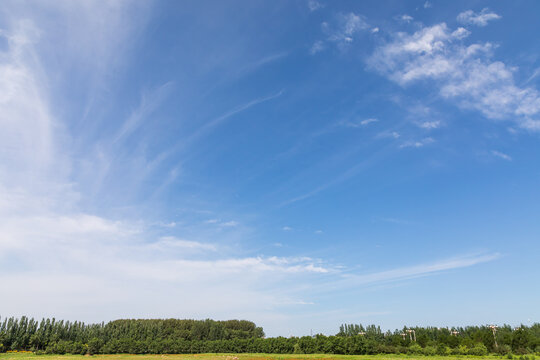 White clouds in the vast sky and the open fields