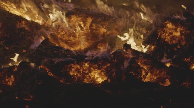 Fire embers particles over black background. Fire sparks background. Abstract dark glitter fire particles lights. 4K Video. 