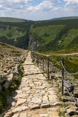 Obraz premium A beautiful, untouched, natural hiking trail with stones leading to mountain Sněžku in the Giant Mountains of the Czech Republic.