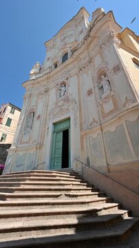 Cervo, liguria, italy. June 22, 2025. Historical baroque facade of san giovanni battista church  with its impressive staircase in the medieval village of cervo, liguria, italy