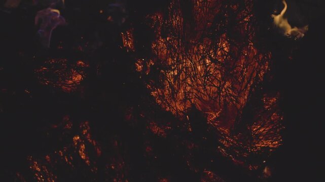 Fire embers particles over black background. Fire sparks background. Abstract dark glitter fire particles lights. 4K Video. 