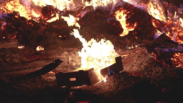 Fire embers particles over black background. Fire sparks background. Abstract dark glitter fire particles lights. 4K Video. 