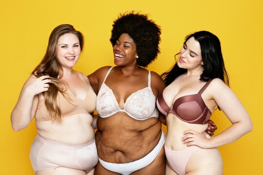 Three women in diverse lingerie styles smiling against a yellow background.