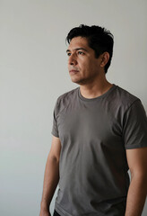 Obraz premium Portrait of a man in plain t-shirt looking away