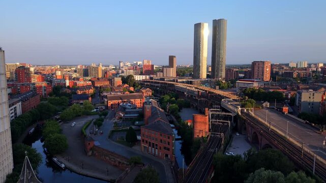 Aerial Video  of Castlefield Basin, Railway Viaducts, and Trinity Island at Sunrise in Manchester, UK. 