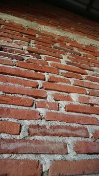 Authentic red brick wall with natural clay tones and gray mortar lines, Perfect for background texture overlays, architectural intros, urban design, motion graphics base layers, rustic or industrial 