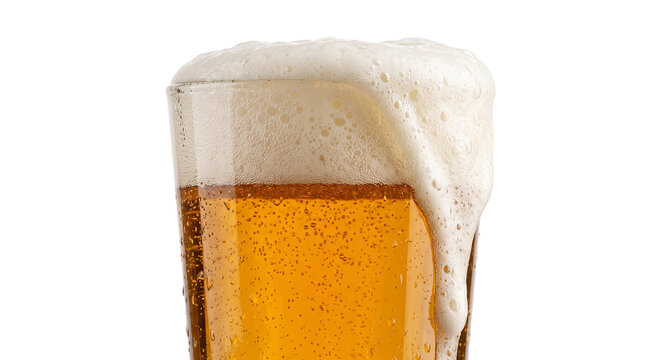 Close up of a refreshing glass of golden beer with overflowing foam