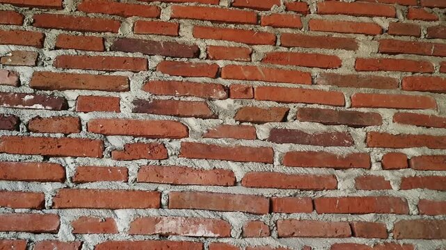 Authentic red brick wall with natural clay tones and gray mortar lines, Perfect for background texture overlays, architectural intros, urban design, motion graphics base layers, rustic or industrial 