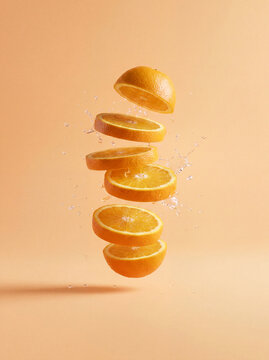 Fresh citrus concept illustration with floating red grapefruit slices and liquid splash, healthy food background