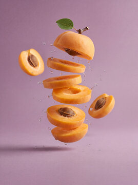 Fresh peach fruit concept with floating peach slices and liquid splash, healthy food background