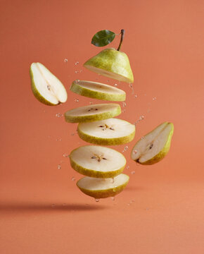 Fresh pear fruit concept illustration with floating pear slices and liquid splash, healthy food background