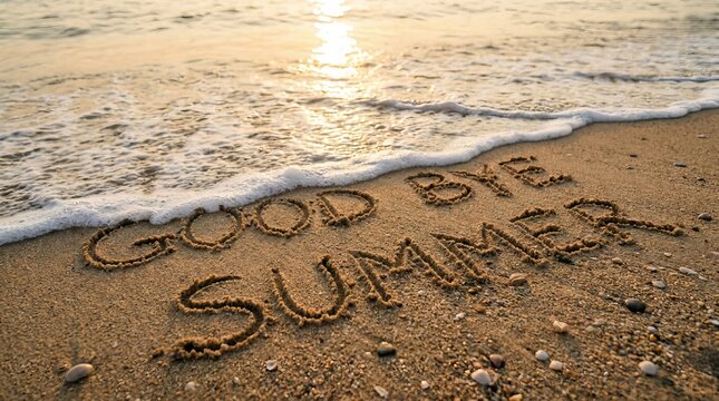 Good Bye Summer Handwritten Message on Sandy Beach with Ocean Waves at Sunset