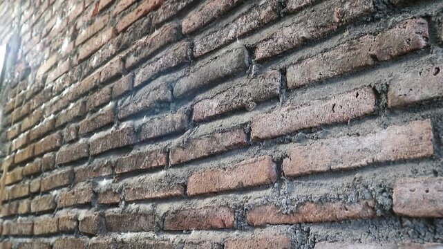 Authentic red brick wall with natural clay tones and gray mortar lines, Perfect for background texture overlays, architectural intros, urban design, motion graphics base layers, rustic or industrial 