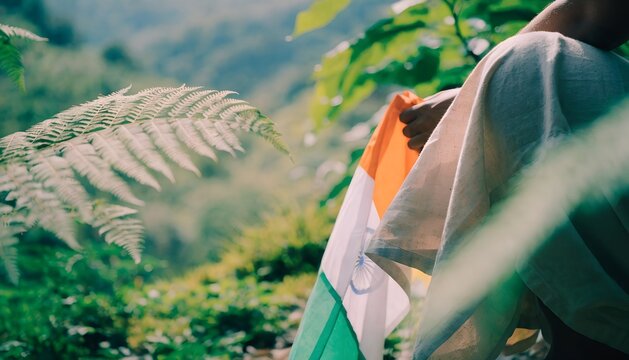 Indian flag held in nature. Tricolor banner for Republic Day celebration.