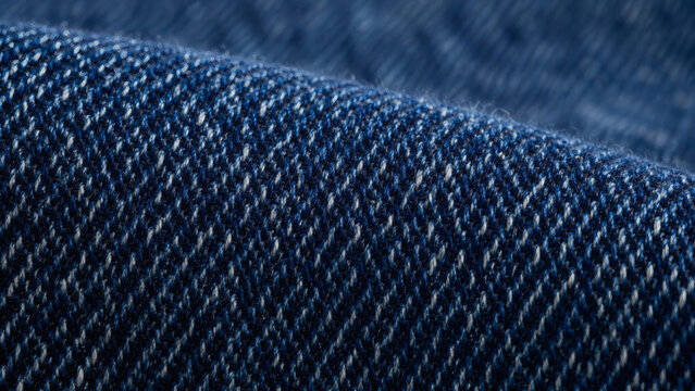 Raw indigo denim fabric texture in macro with diagonal twill weave pattern