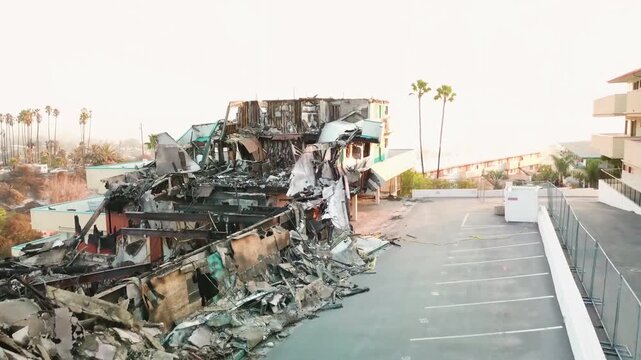 Aerial view of burned apartment building structure after devastating wildfire.