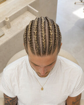 Man with braided hairstyle in a salon
