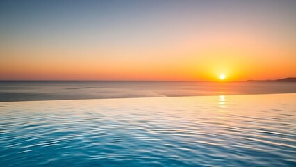 Obraz premium A serene infinity pool with gentle ripples, overlooking the ocean at sunset.