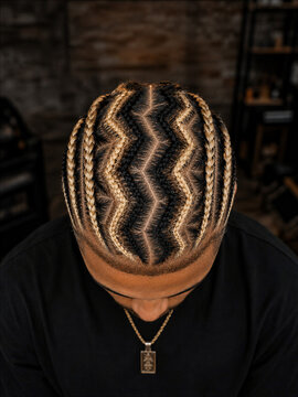 Person with zigzag braided hairstyle looking down