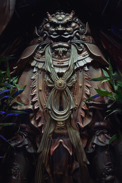 A detailed close-up shot capturing the extraordinary craftsmanship of the armor worn by Wei Tuo (Skanda Bodhisattva), a revered Buddhist Dharma protector. Located inside the historic Luohan Temple in 