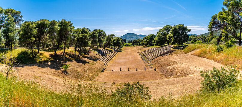 A view towards the Stadium of Epidaurus at the archaeological ruins of the Sanctuary of Asclepius at Epidaurus in early summertime