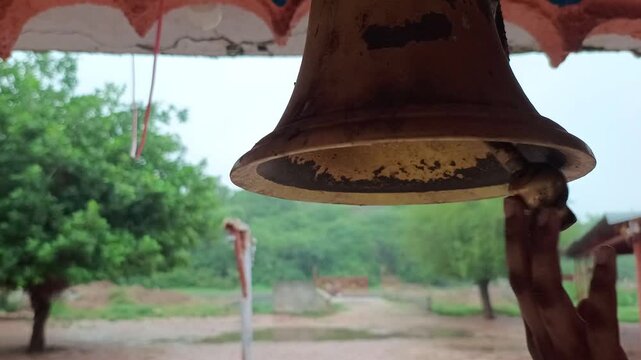 Hand Ringing Brass Bell in Traditional Indian Hindu Temple