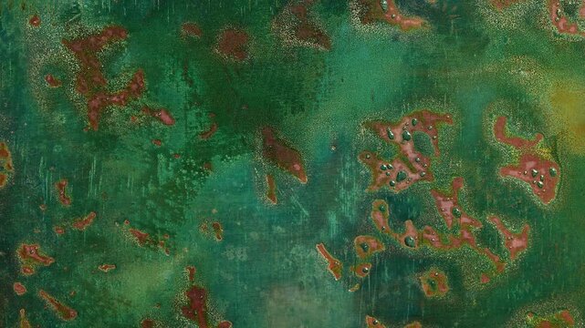 Macro timelapse of copper oxidation creating colorful blue, green and red patina. Natural corrosion forms abstract metallic textures and evolving organic patterns