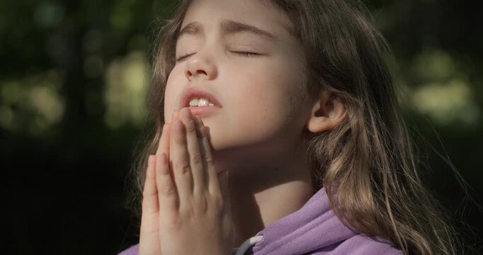 Religion. Child Girl Folded Lifestyle Her Hands in Prayer Pray to God on Outdoor. Worried Teenager Girl Looking for Hope and Faith Praying to God. Religious Child With Hope in His Heart Prays to God.
