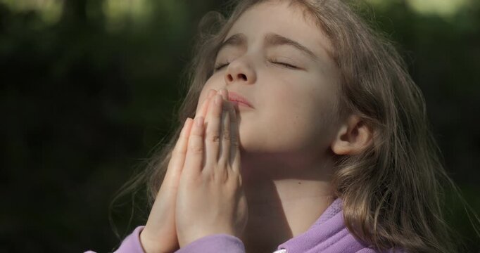 Religion. Child Girl Folded Lifestyle Her Hands in Prayer Pray to God on Outdoor. Worried Teenager Girl Looking for Hope and Faith Praying to God. Religious Child With Hope in His Heart Prays to God.