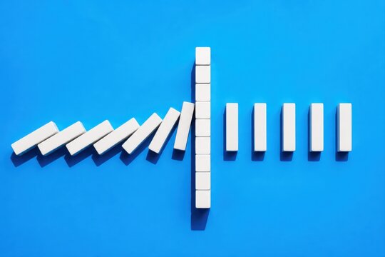 Dominoes forming a chain reaction on a blue background