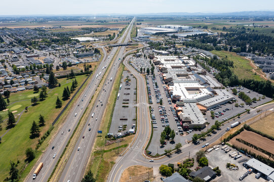 Aerial drone photo of Interstate 5 (I-5) and highway interchange with connecting ramps near Woodburn, Oregon, USA showing regional transportation infrastructure and commuter traffic