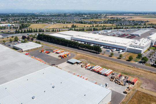 Woodburn, Oregon, USA - June 19, 2026 - Aerial drone photo of Do it Best Corp. Woodburn Regional Support Center warehouse with loading docks, trailers and logistics operations on Juneteenth