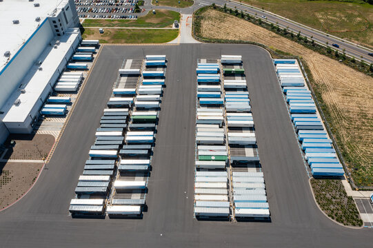 Woodburn, Oregon, USA - June 19, 2026 - Aerial drone photo of Amazon Fulfillment Center PDX8 with warehouse buildings, loading docks, trailers and logistics operations