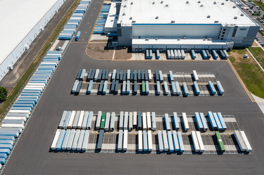 Woodburn, Oregon, USA - June 19, 2026 - Aerial drone photo of Amazon Fulfillment Center PDX8 with warehouse buildings, loading docks, trailers and logistics operations