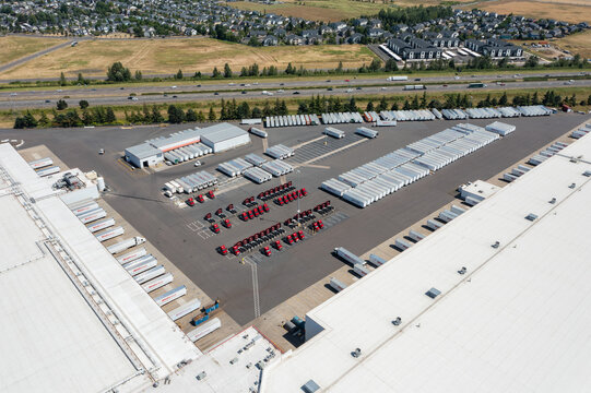Woodburn, Oregon, USA - June 19, 2026 - Aerial drone photo of WinCo Foods Distribution Center with warehouse, loading docks, truck trailers and logistics operations during Juneteenth