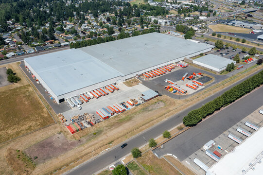 Woodburn, Oregon, USA - June 19, 2026 - Aerial drone photo of Do it Best Corp. Woodburn Regional Support Center warehouse with loading docks, trailers and logistics operations on Juneteenth