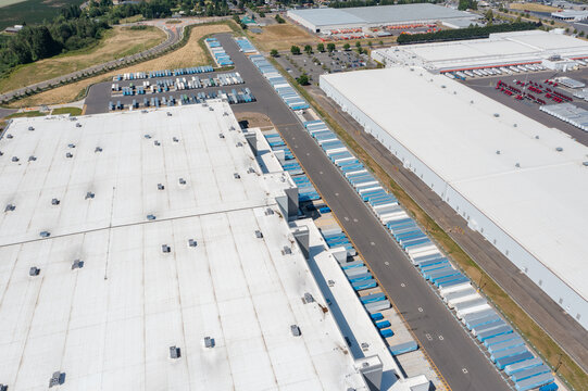Woodburn, Oregon, USA - June 19, 2026 - Aerial drone photo of Amazon Fulfillment Center PDX8 with warehouse buildings, loading docks, trailers and logistics operations