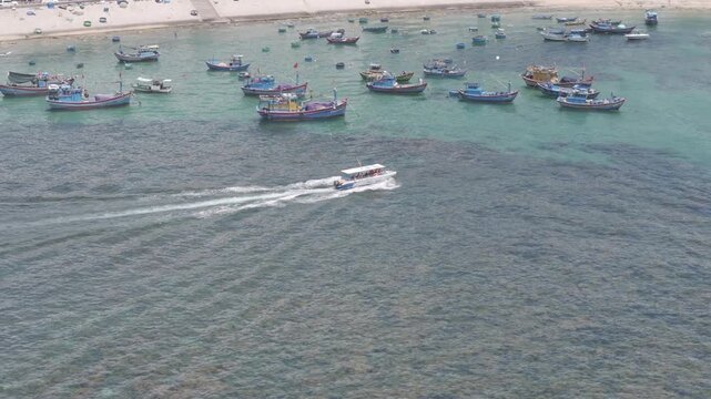Aerial drone footage of kayaking over seaweed beds at Hon Kho, Gia Lai, Vietnam, featuring crystal-clear water, tropical coastline and an active outdoor adventure near Quy Nhon.